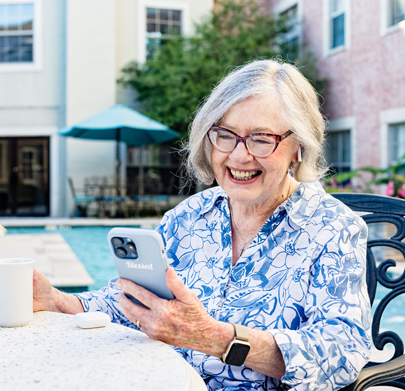 Senior woman outside with coffee talking on the phone about trusted support