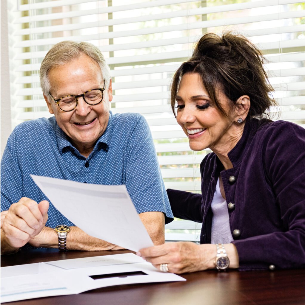 A senior man and female caregiver going over next steps after selecting a community