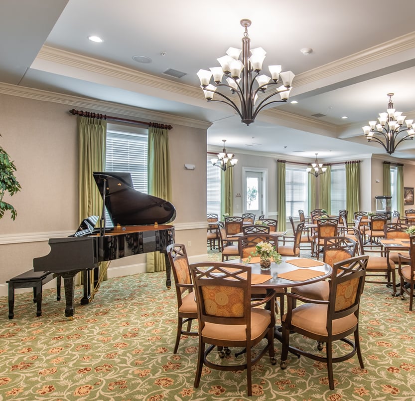 The Addison of Port Orange dining area with piano
