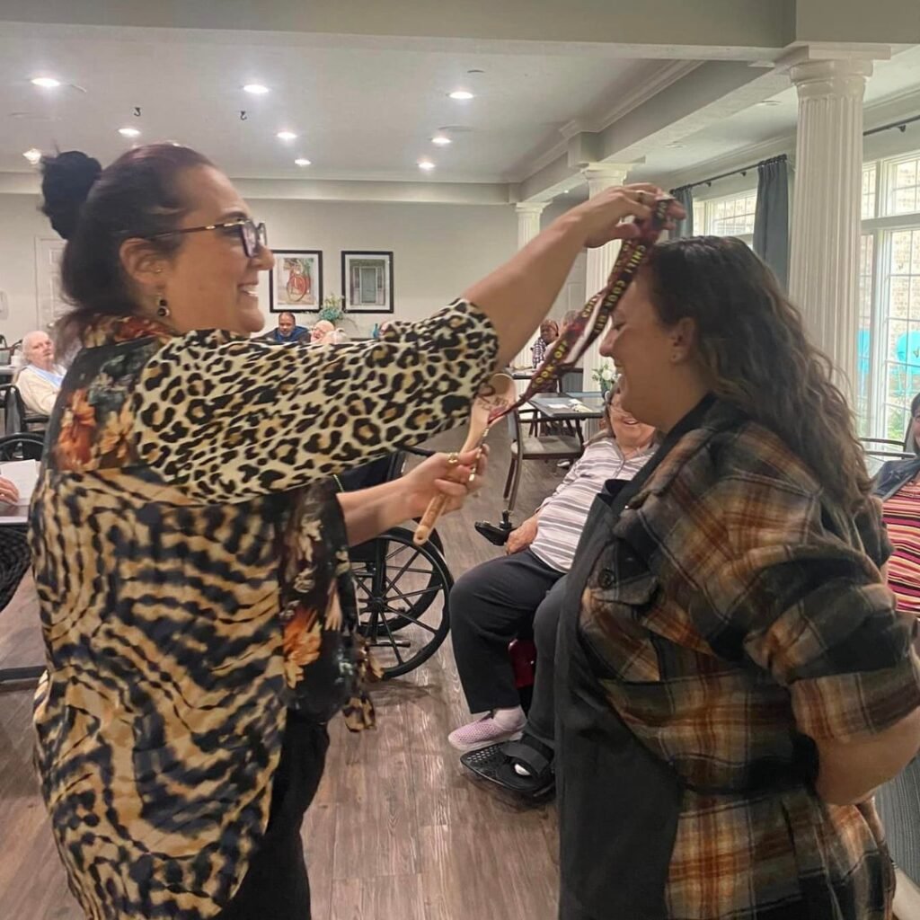 Team member being crowned a chili cook-off second place champion