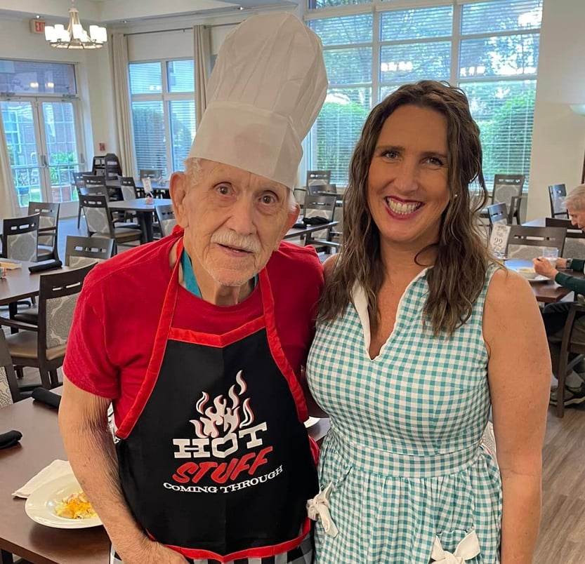 Tree of Dreams fulfilled as a man poses with an activity director after he cooked chilli