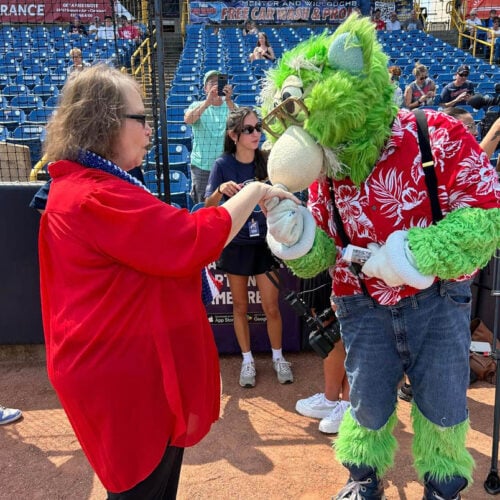Tree of Dreams wish fulfilled as a resident poses with a college mascot after she experienced graduating school.