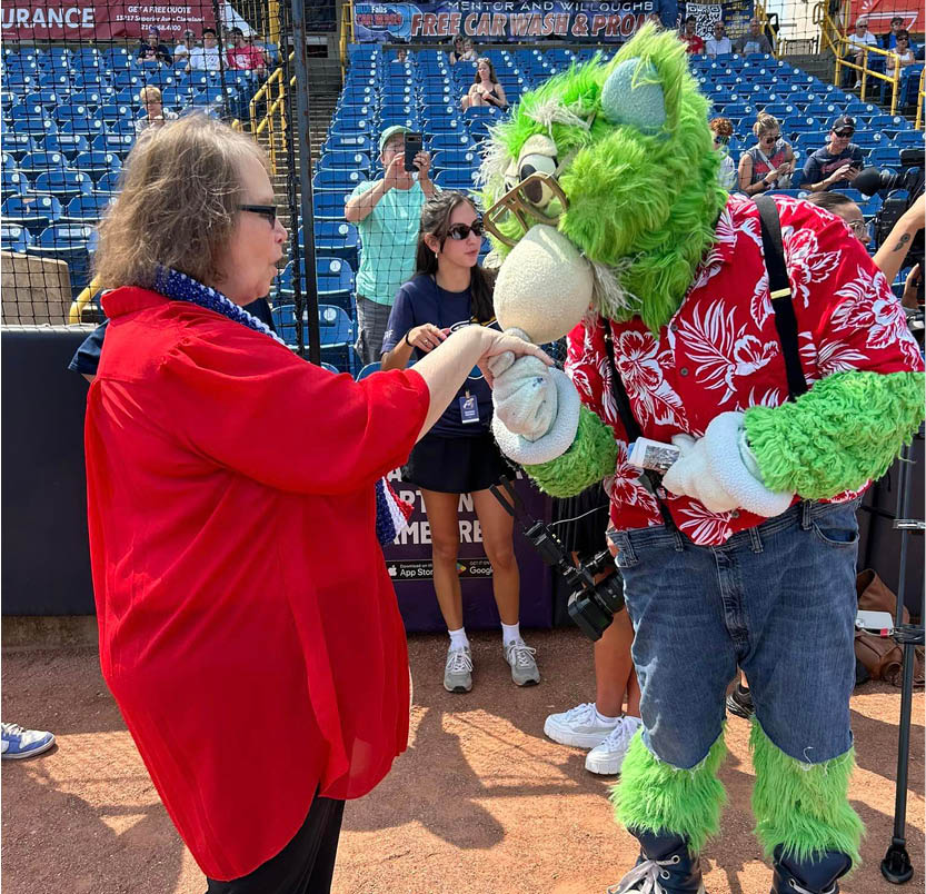 Tree of Dreams wish fulfilled as a resident poses with a college mascot after she experienced graduating school.