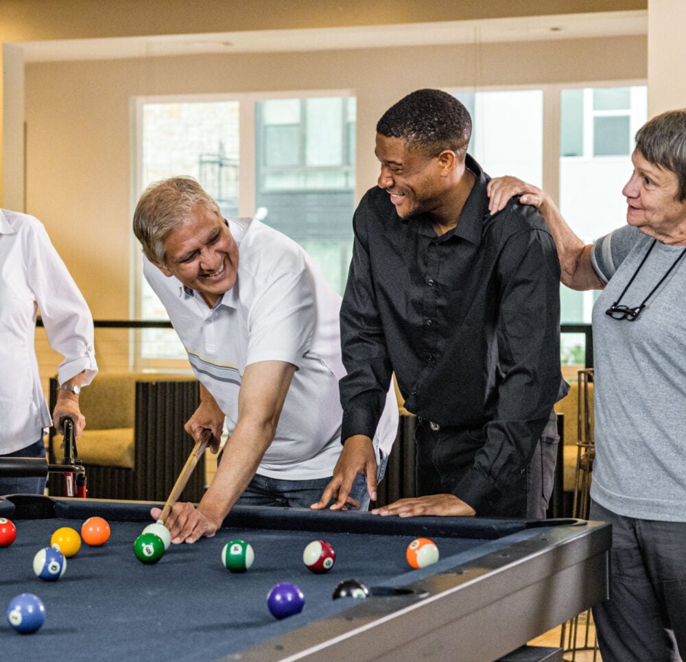 Seniors at a community playing pool