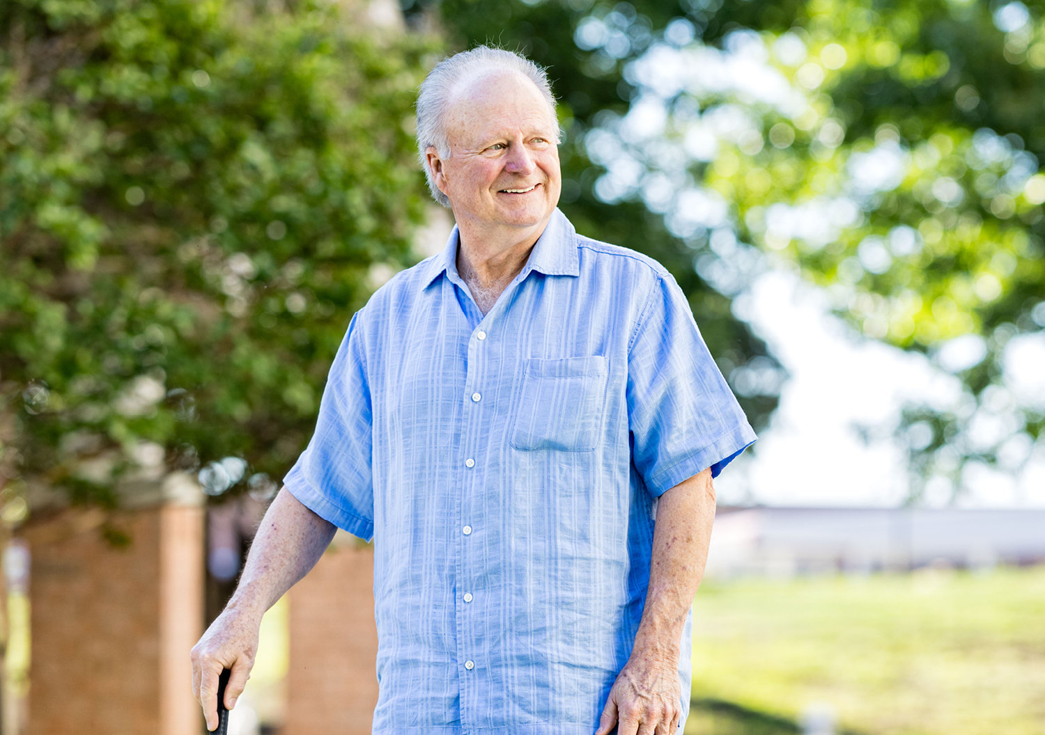 Senior man posing with a smile outside before moving to a senior community