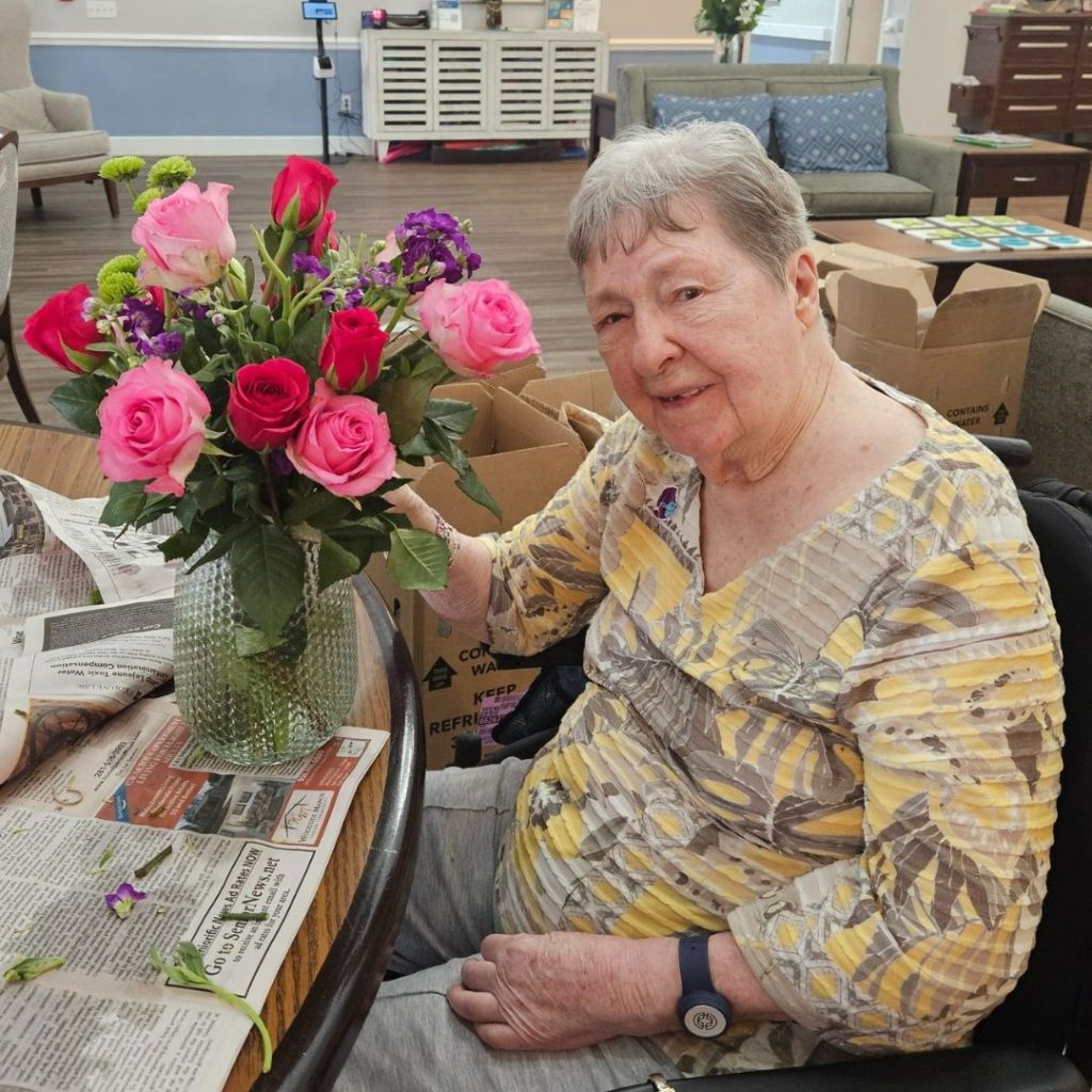 Resident enjoying floral arrangements for community