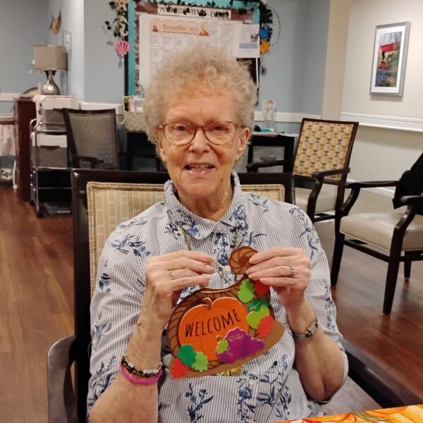 Georgetowne resident holds up Thanksgiving craft