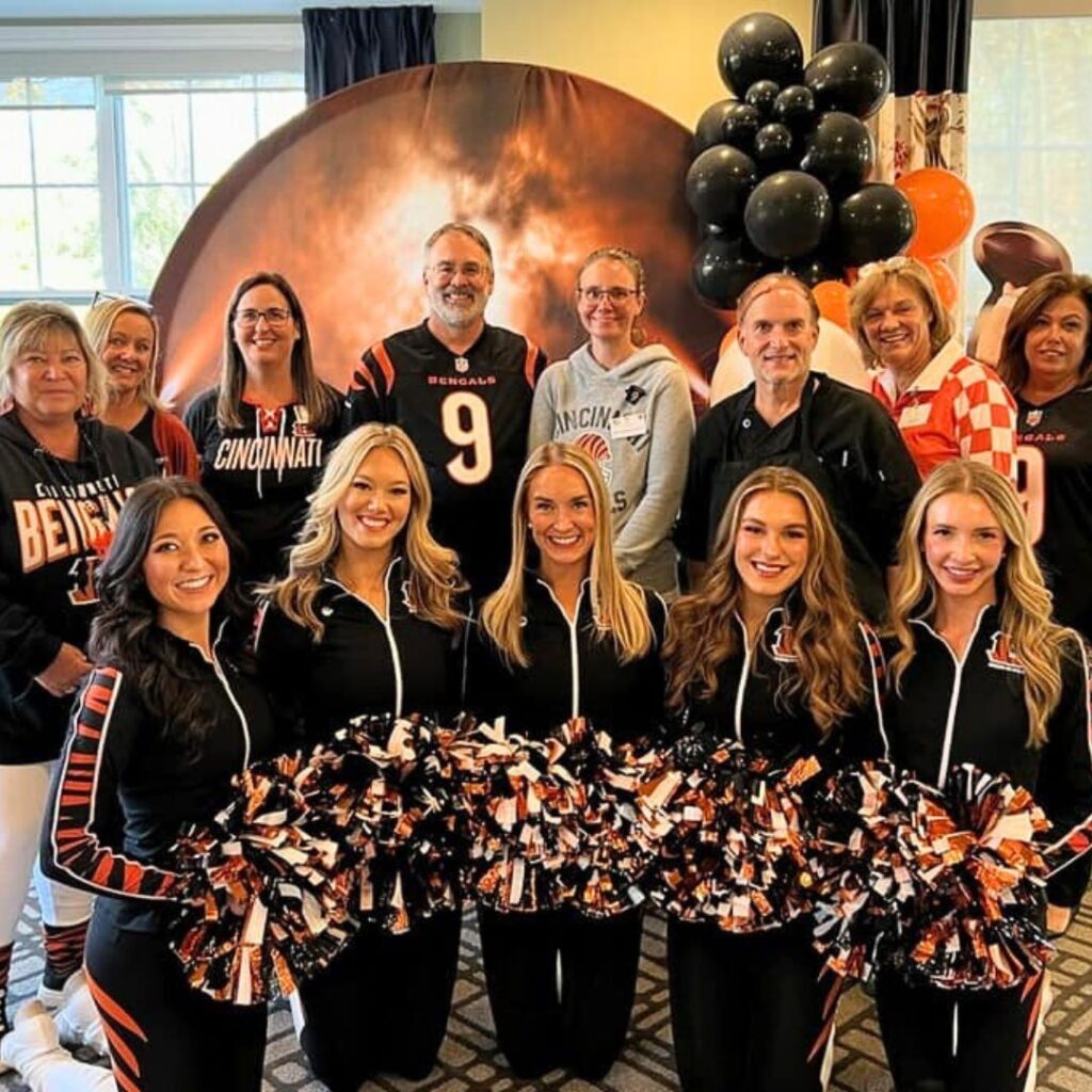 Bengals cheerleaders pose with community leadership team