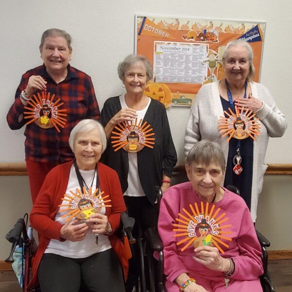 Group of Riverbend residents showing their turkey crafts