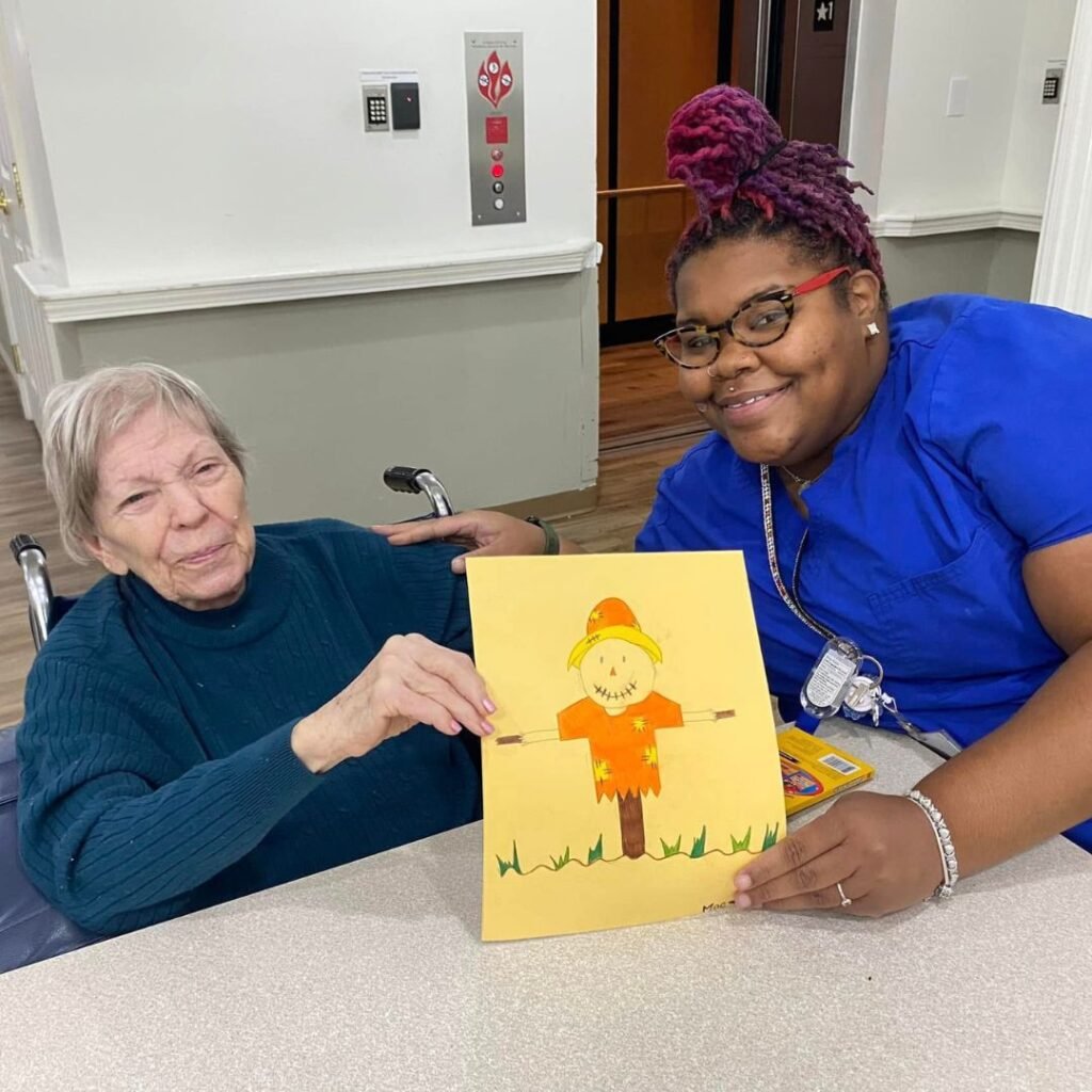 Team member creates festive art with Magnolia Trails residents