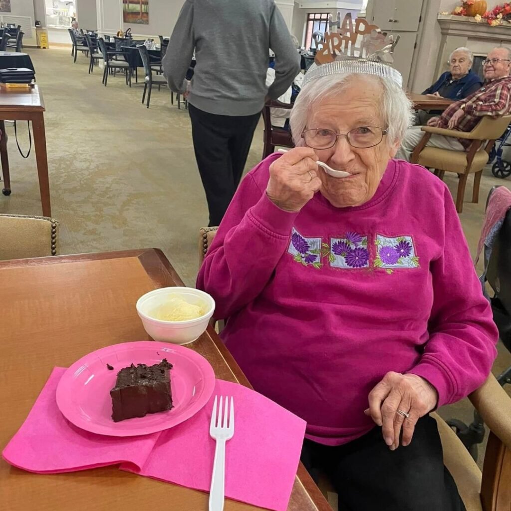Resident Kathleen celebrating her 100th birthday with cake