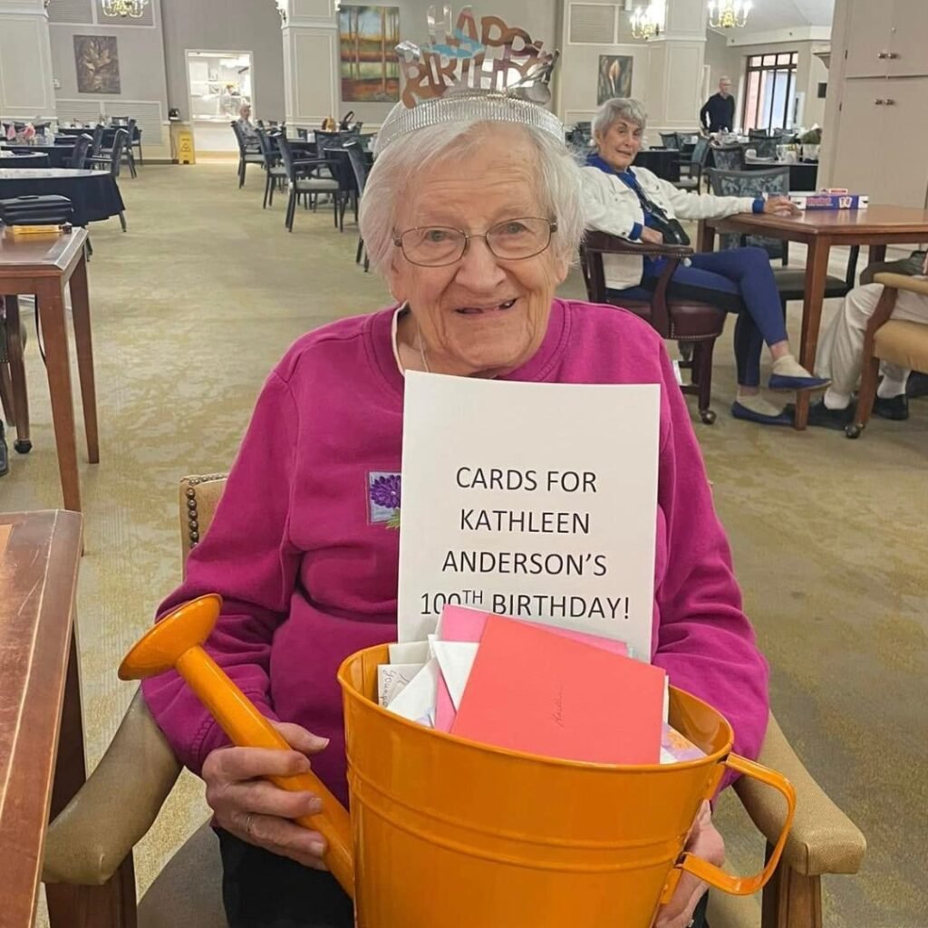 Resident Kathleen celebrating her 100th birthday with 100 cards