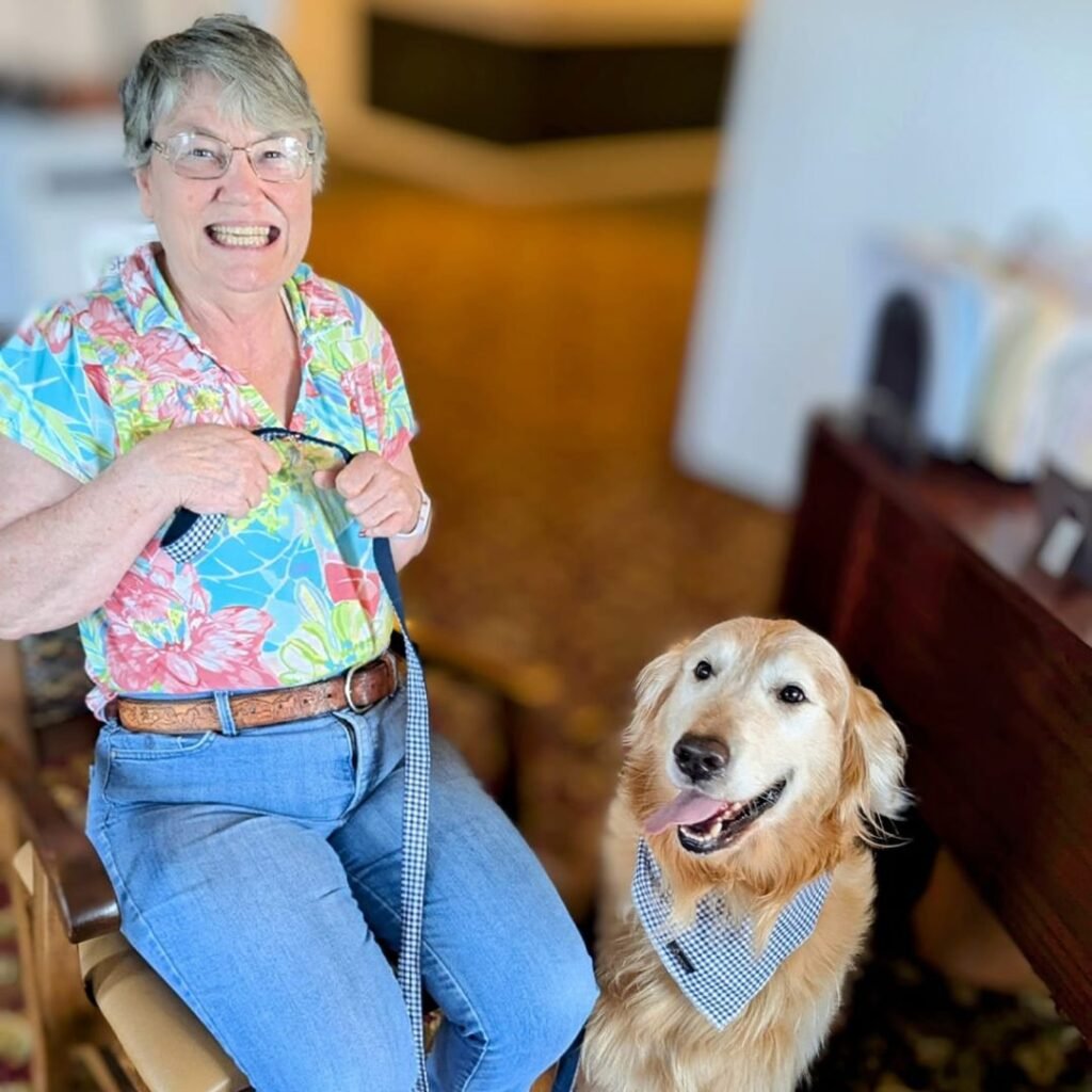 Resident smiles with pet Golden Retriever