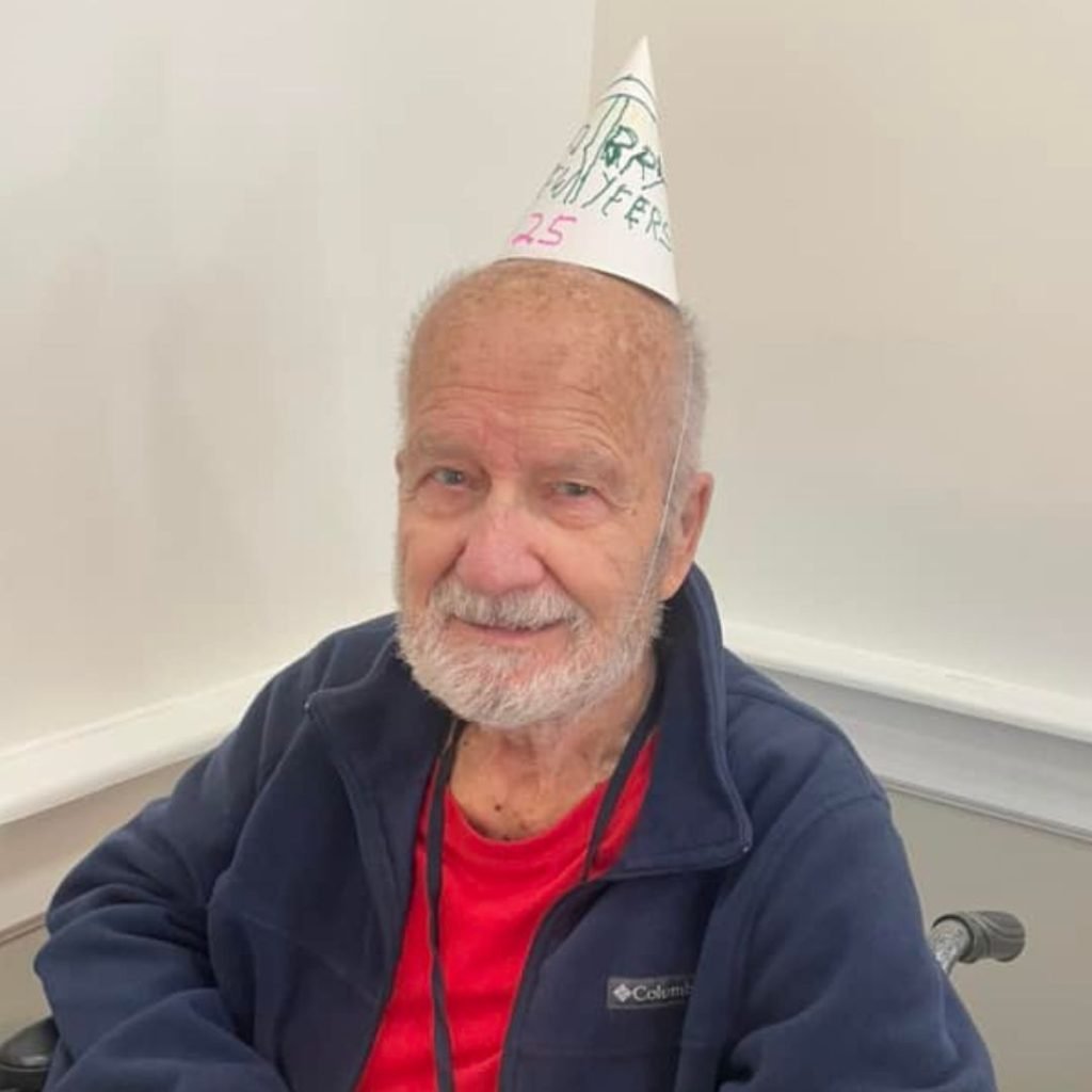 Resident poses with hat he created for New Years festivities