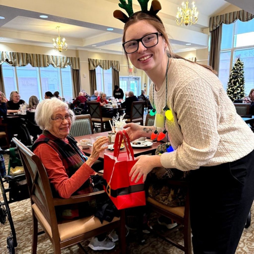 Mansfield team member hands out Christmas presents to residents