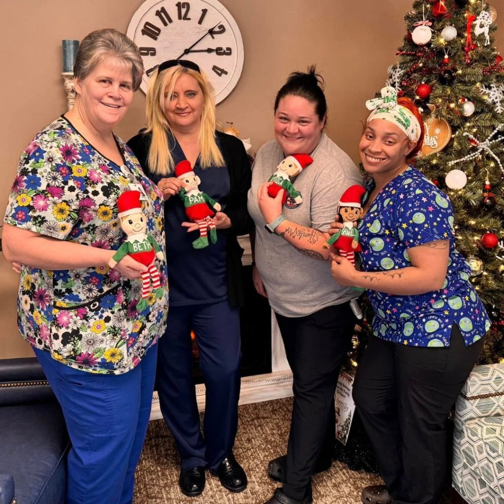 Team members enjoy their personalized elf doll gifts