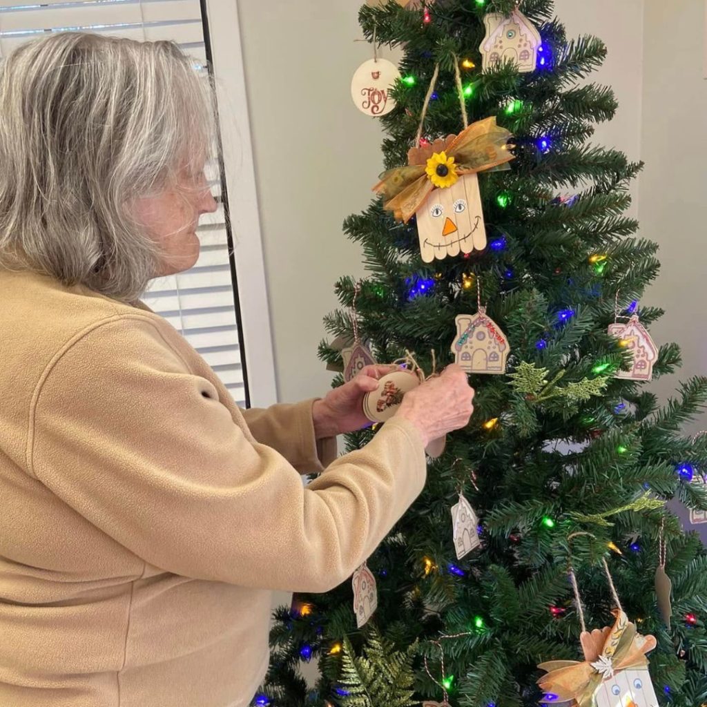 Resident decorates community Christmas tree