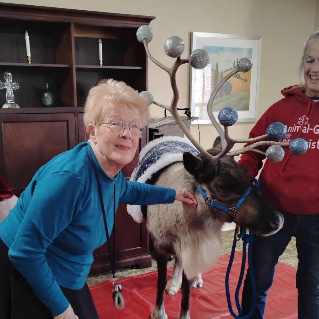 Resident poses with reindeer