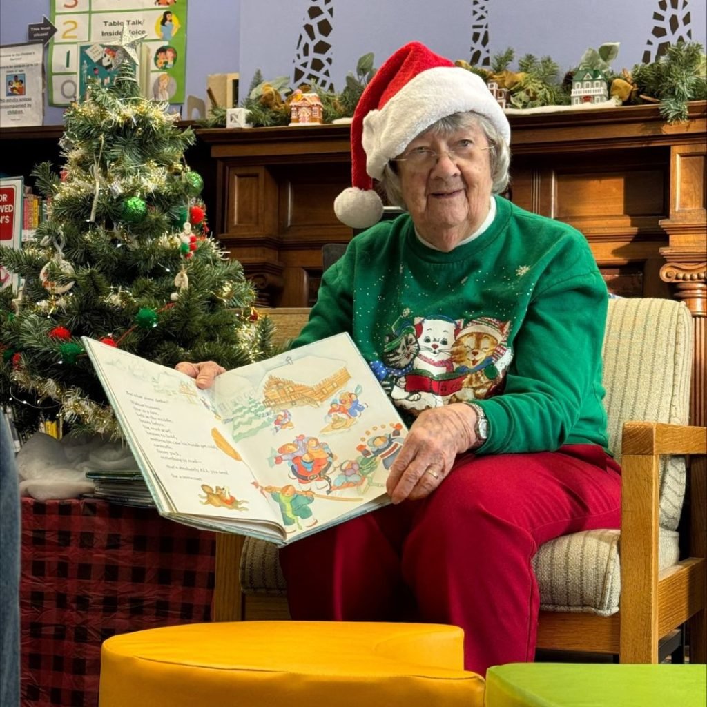 Resident reads Christmas stories to children at local library for her Tree of Dreams