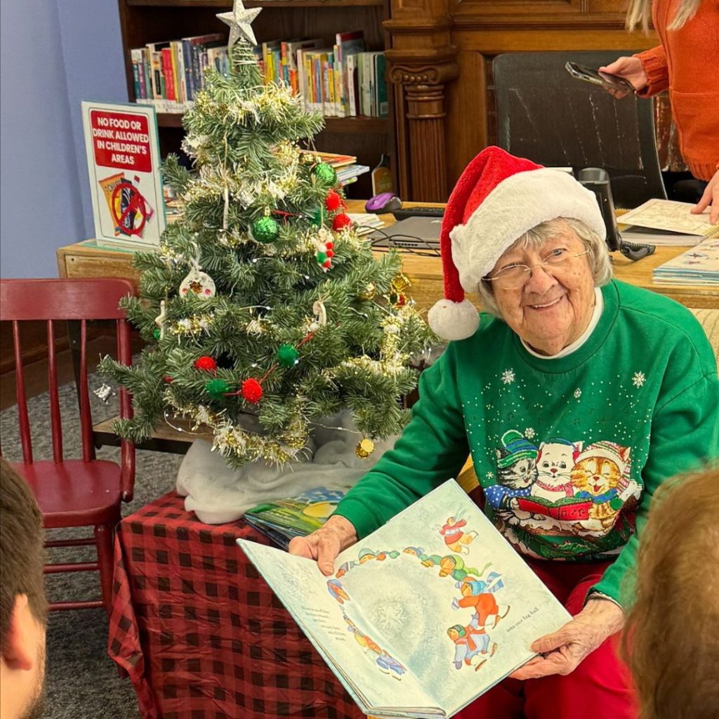 Resident reads to children at local library for her Tree of Dreams