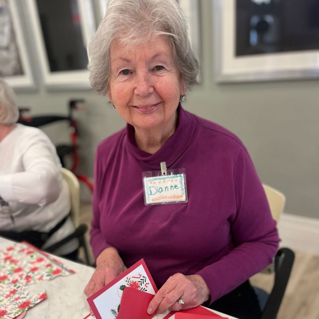 Resident handcrafts Christmas cards to send to her loved ones