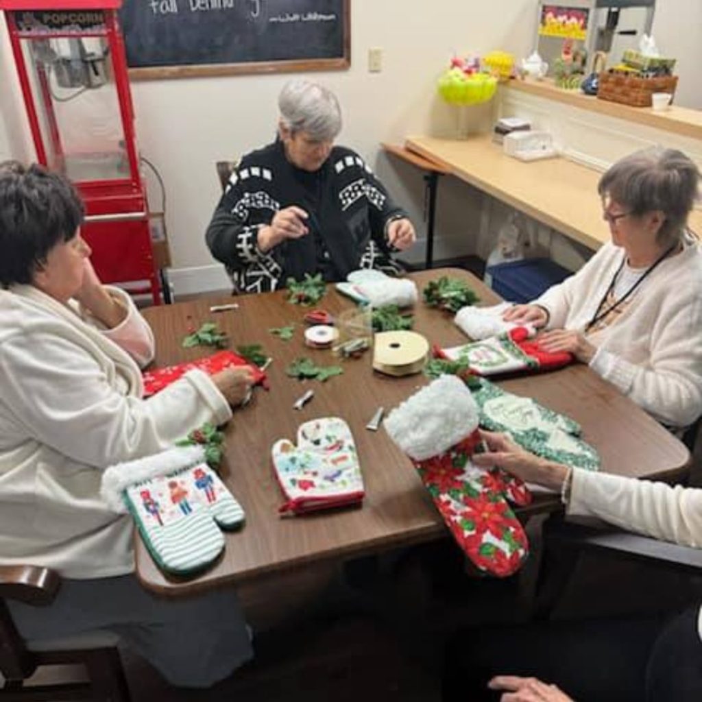 A group of residents create oven mitt stockings