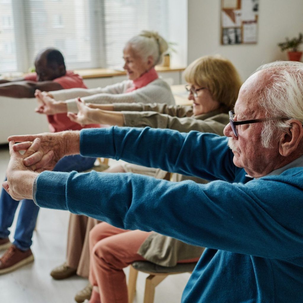 A group of seniors partake in chair exercise routines