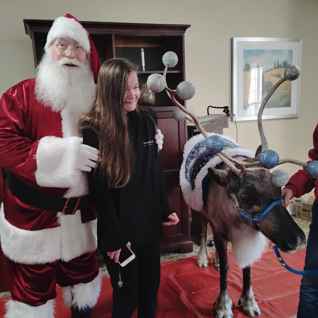 Santa and team member with reindeer
