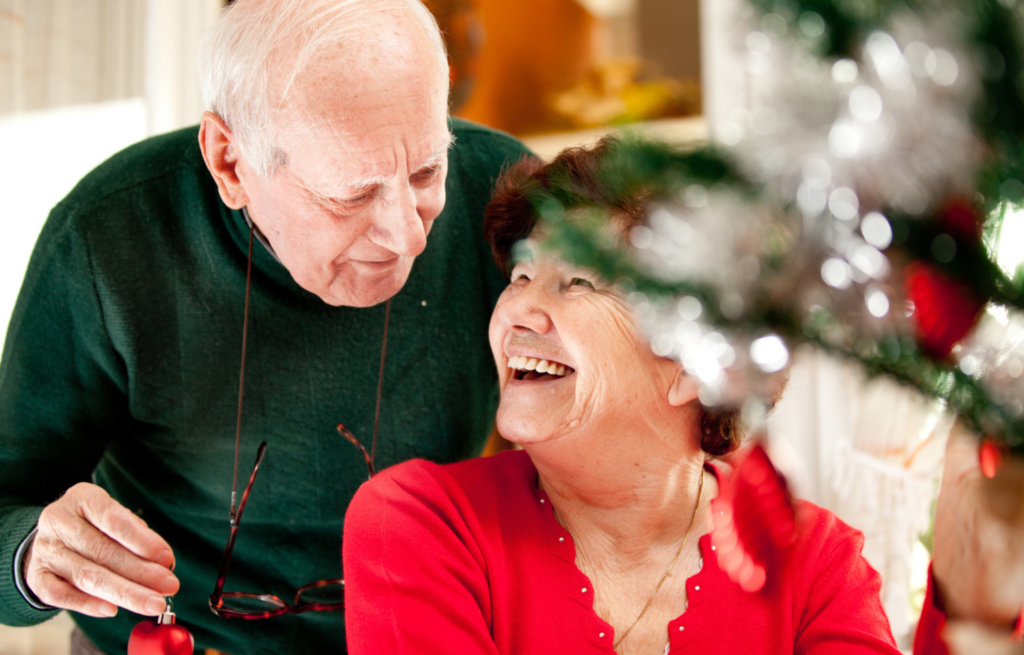 Senior couple decorating Christmas tree