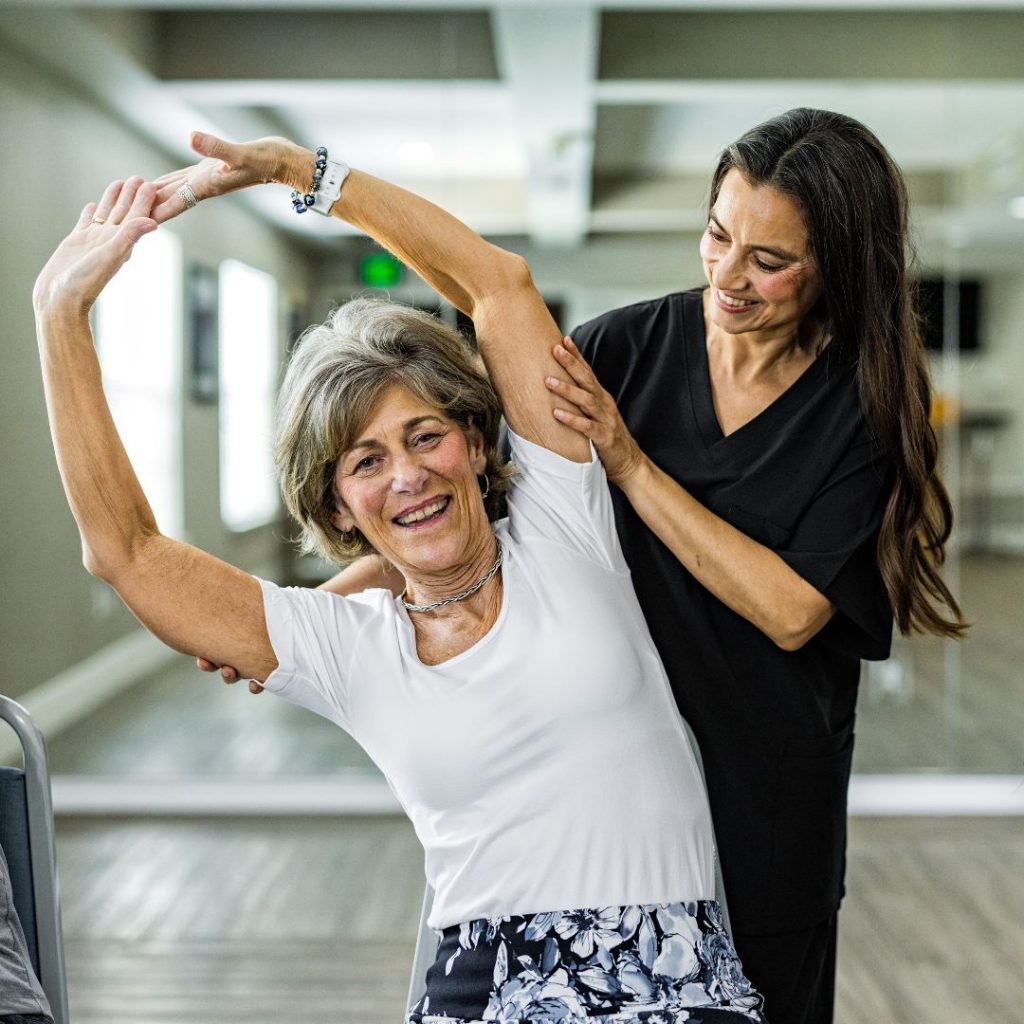 Senior stretching with instructor before exercise