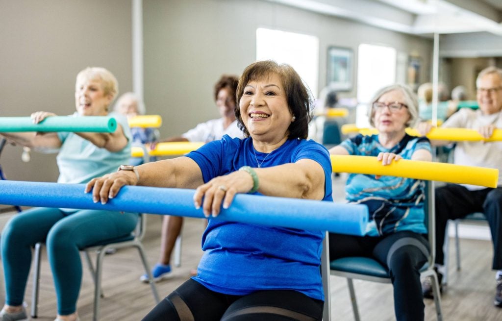 Senior wellness class with chair exercises