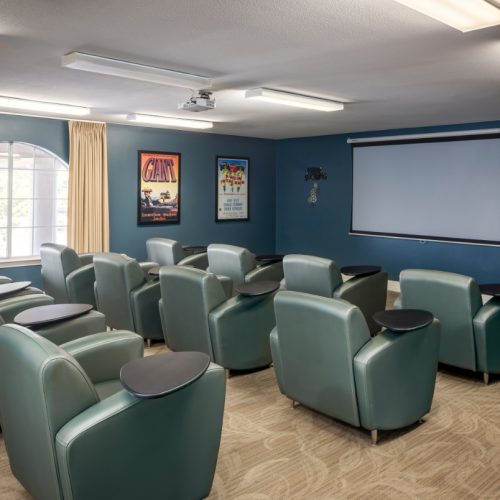 Movie theater room at a senior living community with oversized viewing chairs in Baytown, Texas