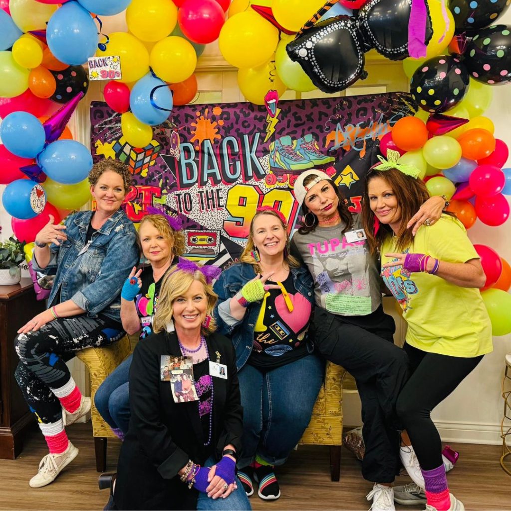 Team poses for throwback party photo