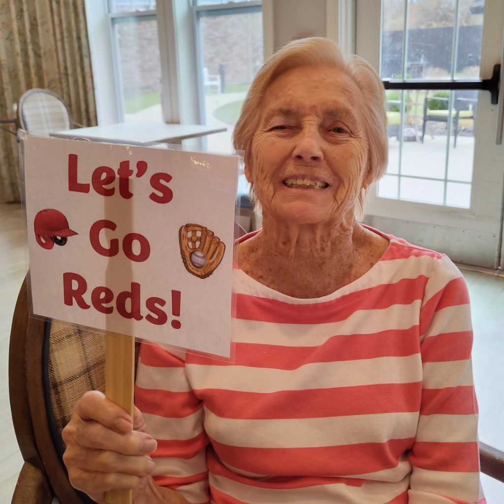 Resident holds Lets Go Reds sign
