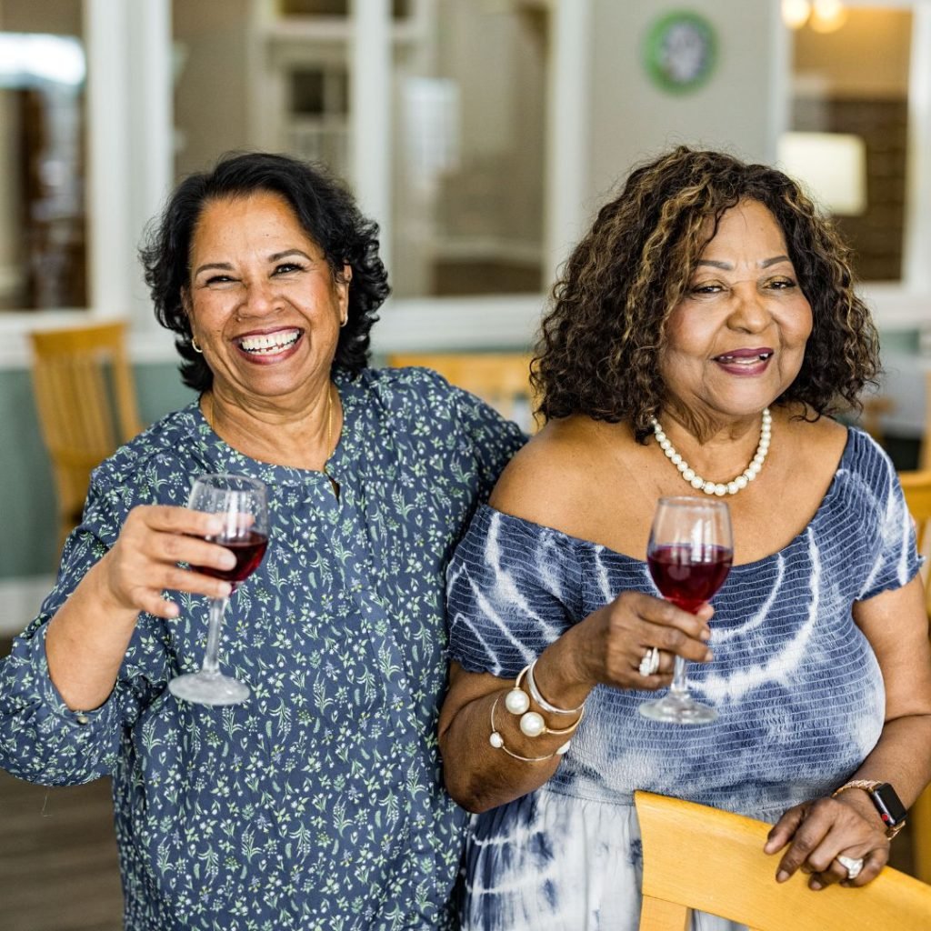 Resident's cheers with wine during happy hour