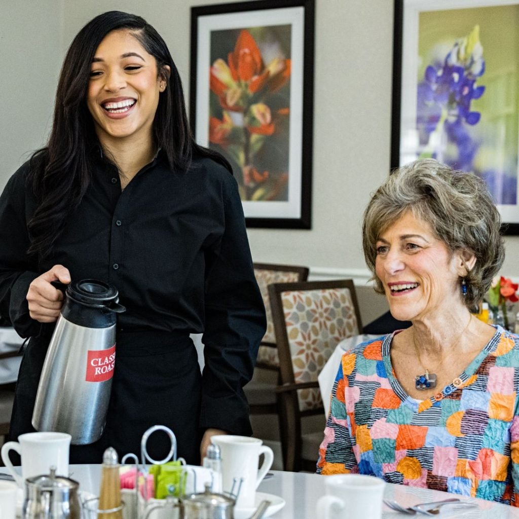 Resident and team member smiling during coffee service