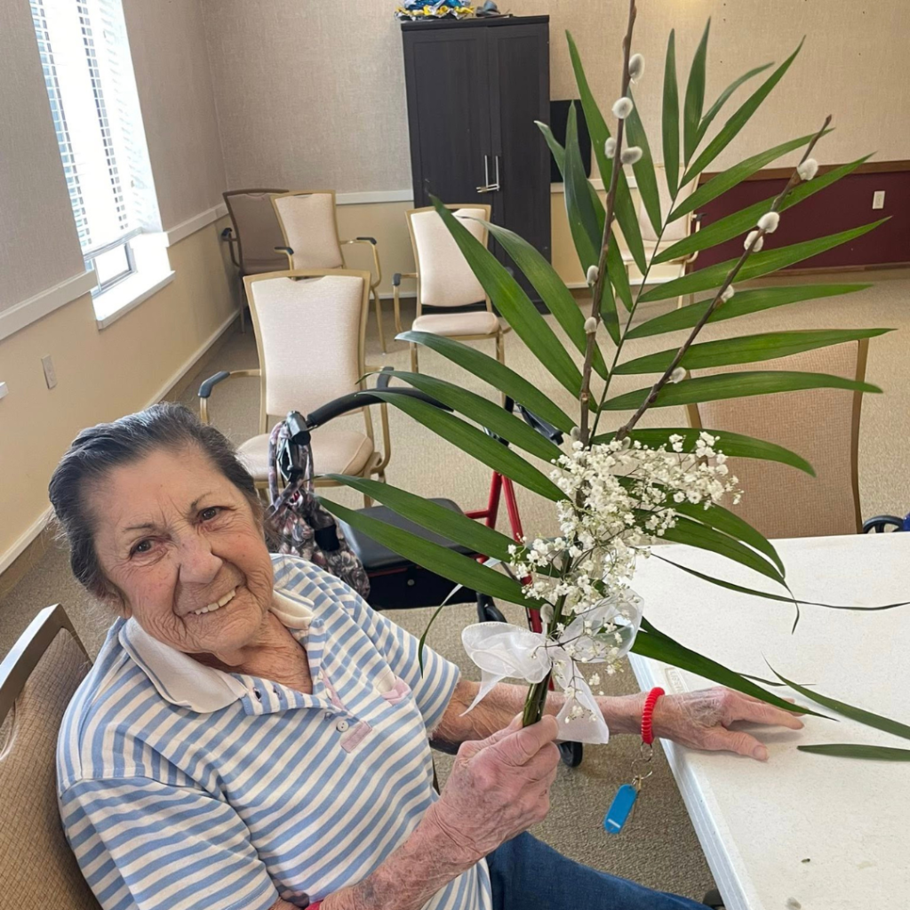 Resident making floral arrangement