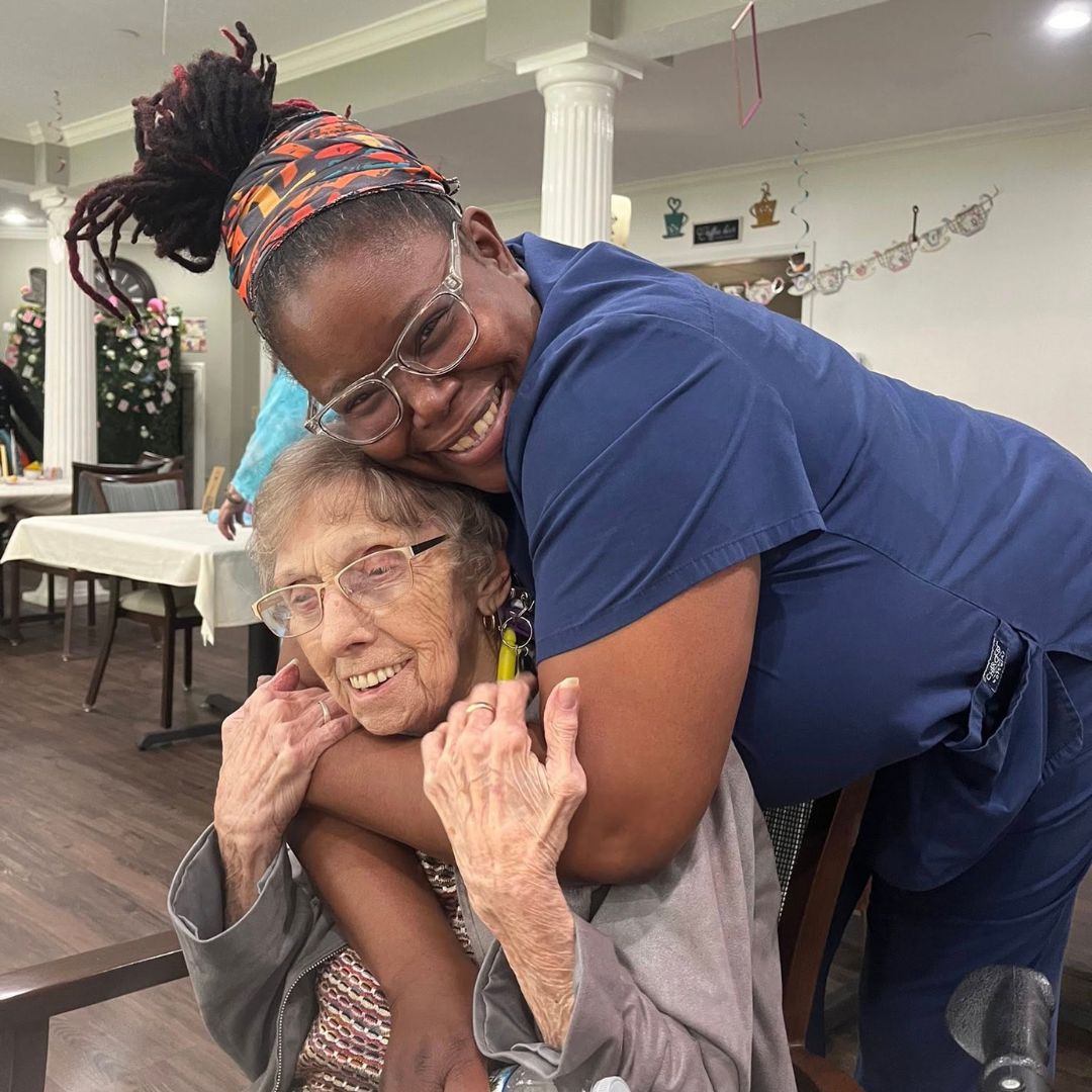 Resident and team member embracing at Mother's Day tea