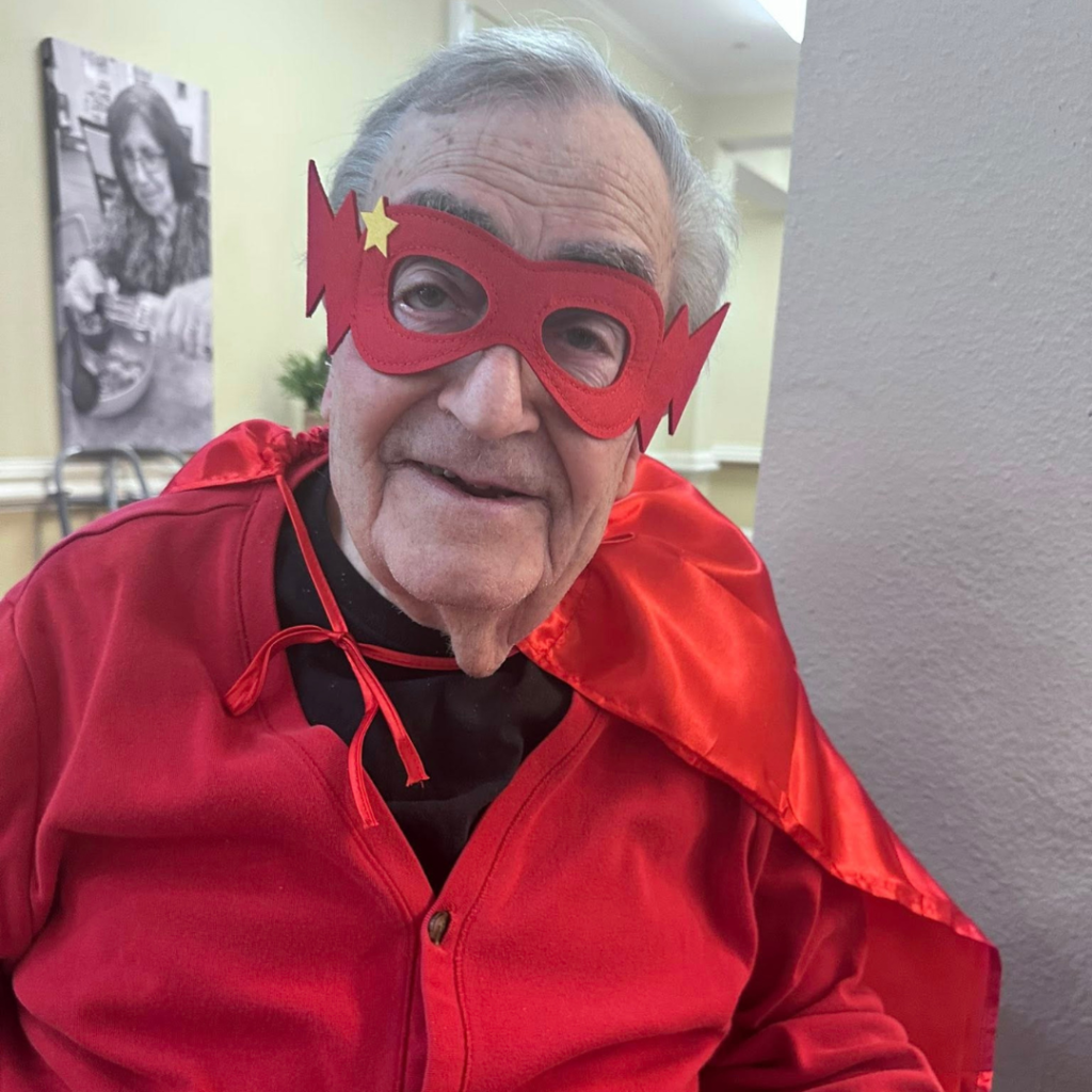Resident dresses up in matching superhero cape and mask