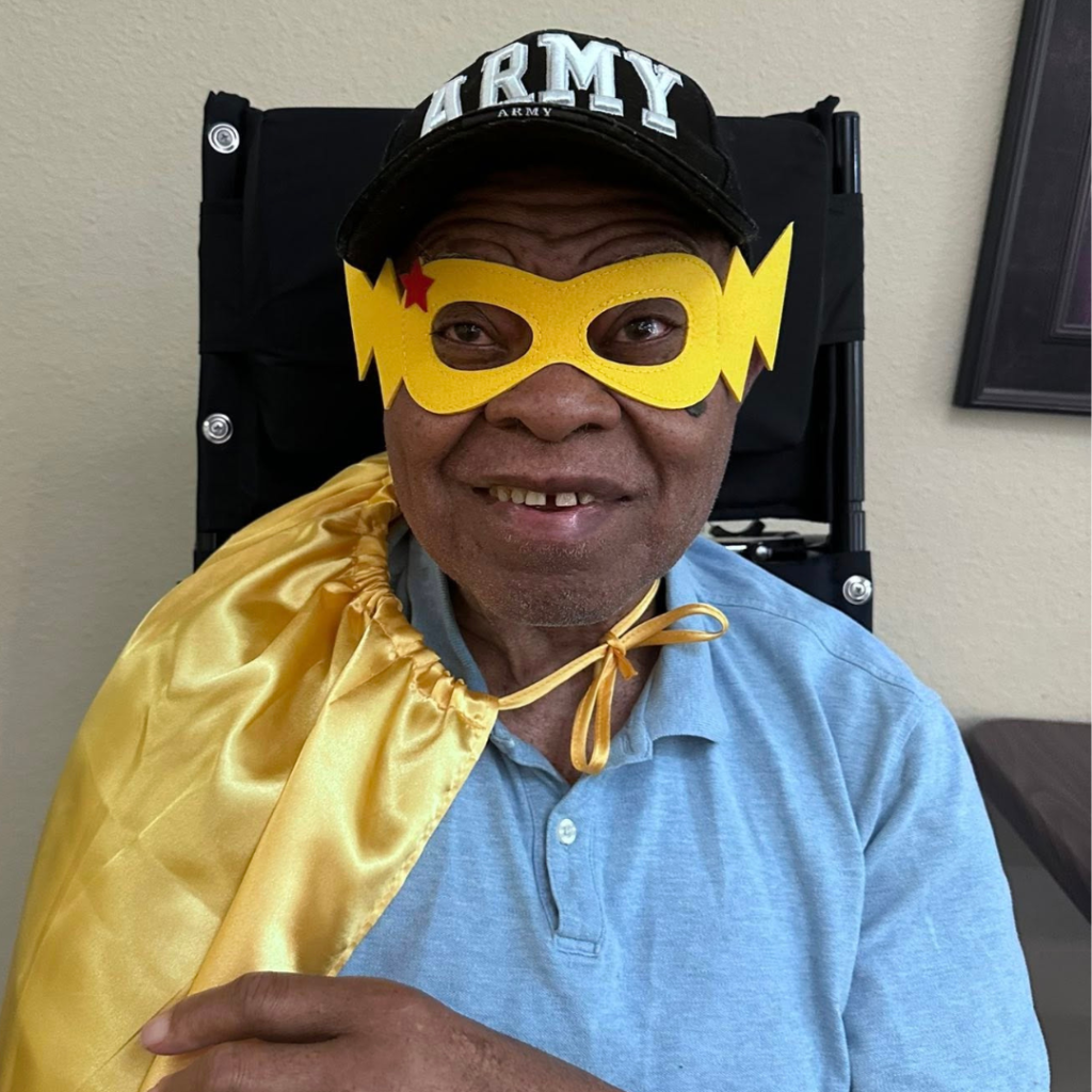 Resident smiles as he sports superhero costume