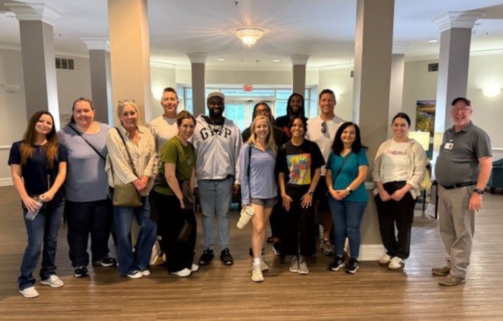 Support Center finance team poses for group photo at community