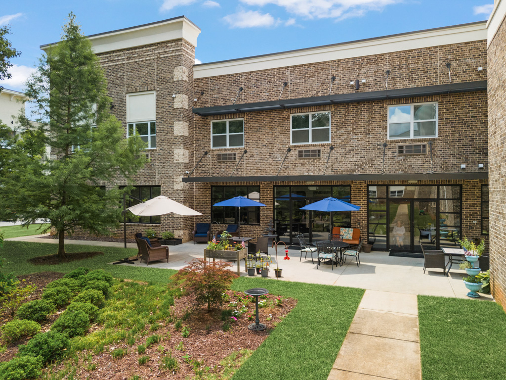 Scenic garden patio with seating at The Addison of Alpharetta in Alpharetta, Georgia.