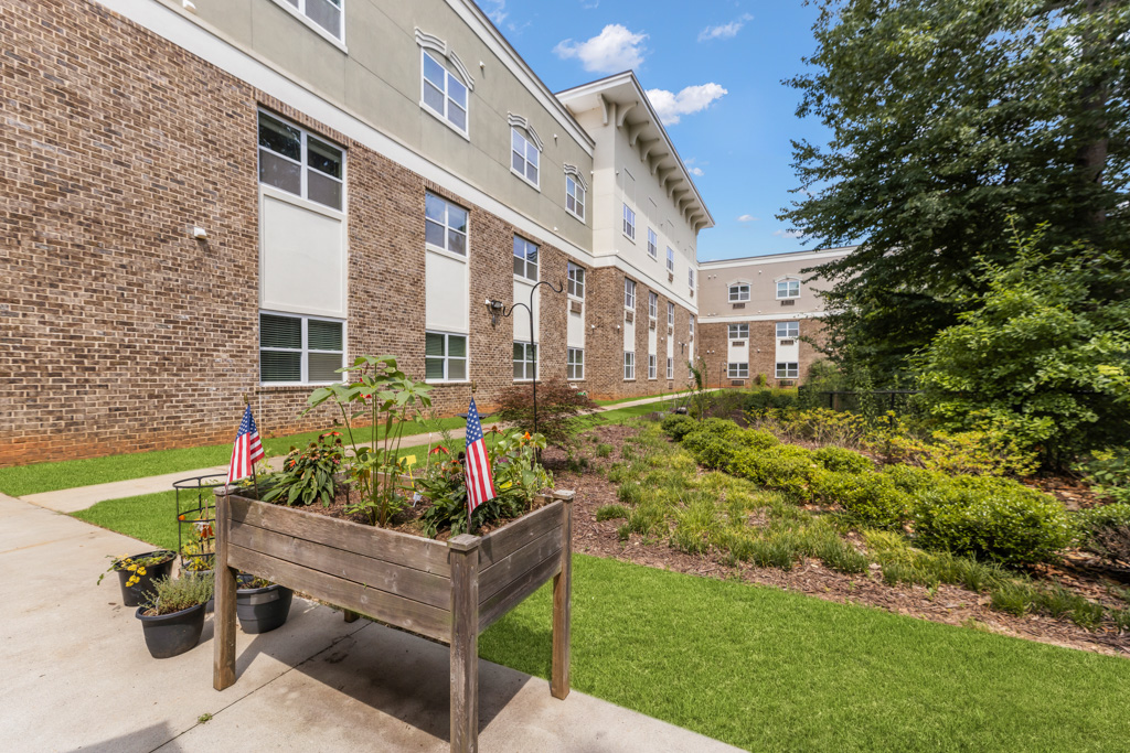 Outdoor garden patio at The Addison of Alpharetta senior living community.