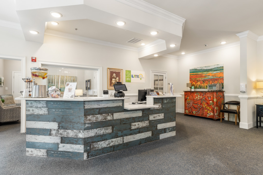 Front desk and reception area at The Addison of Alpharetta senior living community.