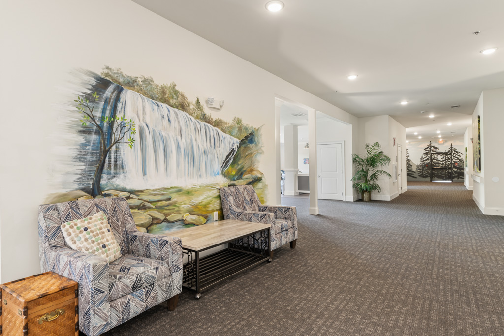 Hallway with decorative art mural at The Addison of Alpharetta assisted living community.
