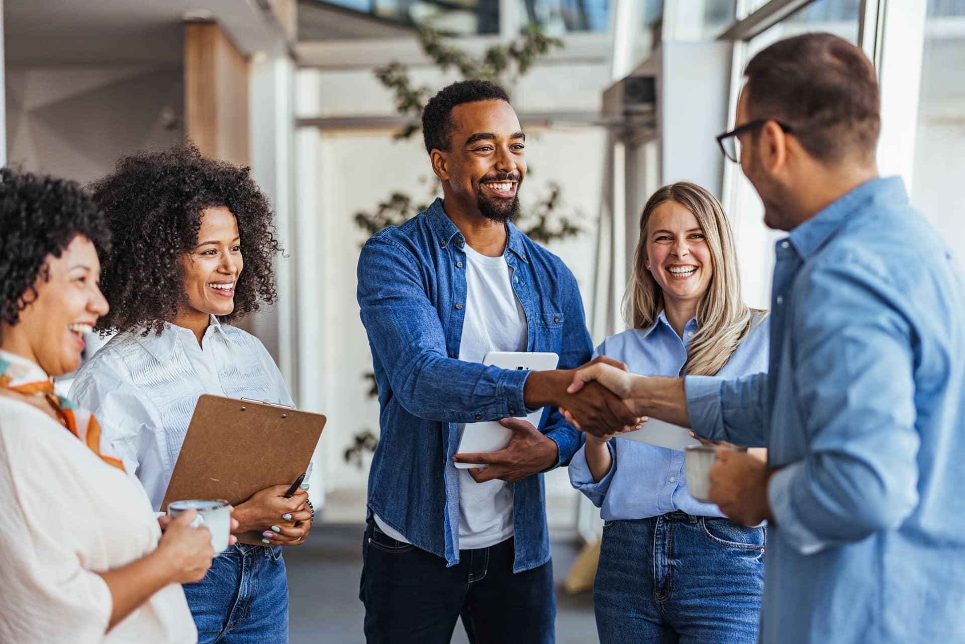 A group of team members meet and shake hands with a candidate