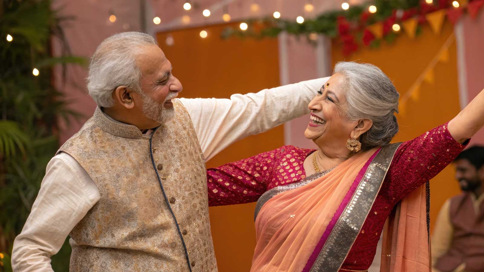 Elderly Indian couple dance at an event