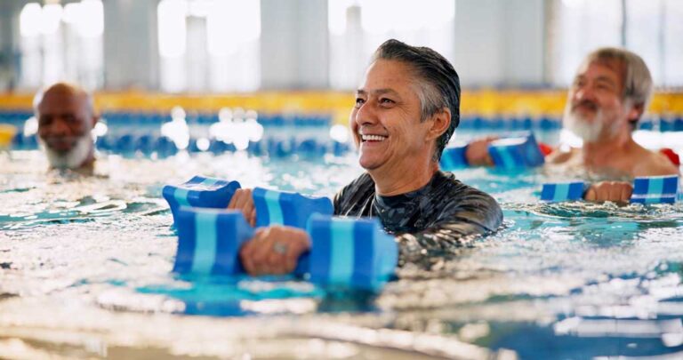 Elderly man exercises in pool
