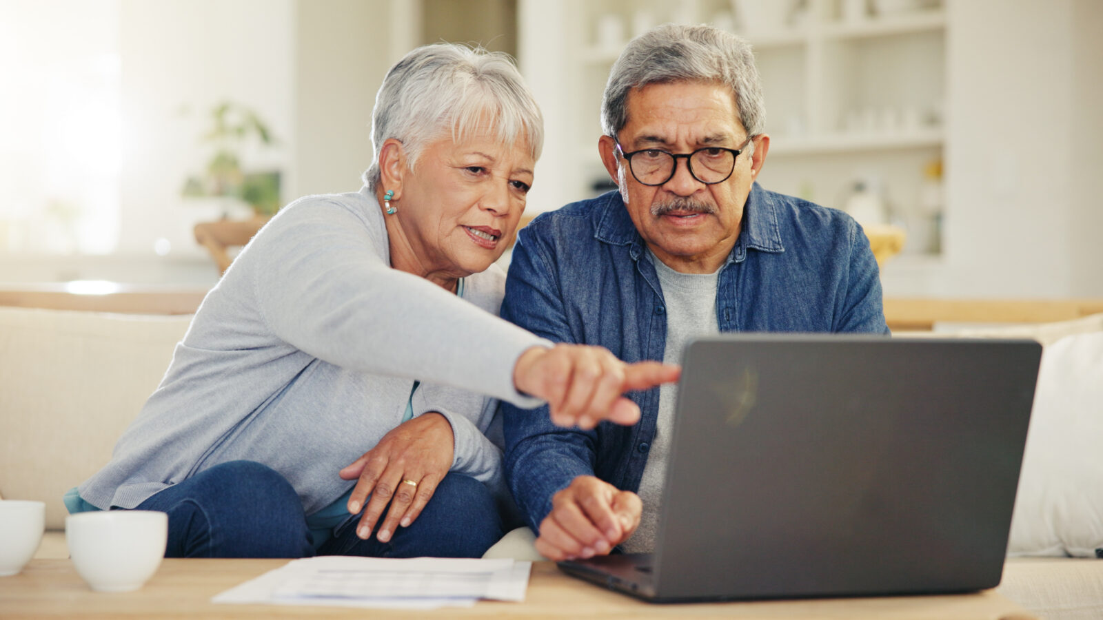 stock senior couple plan together using laptop