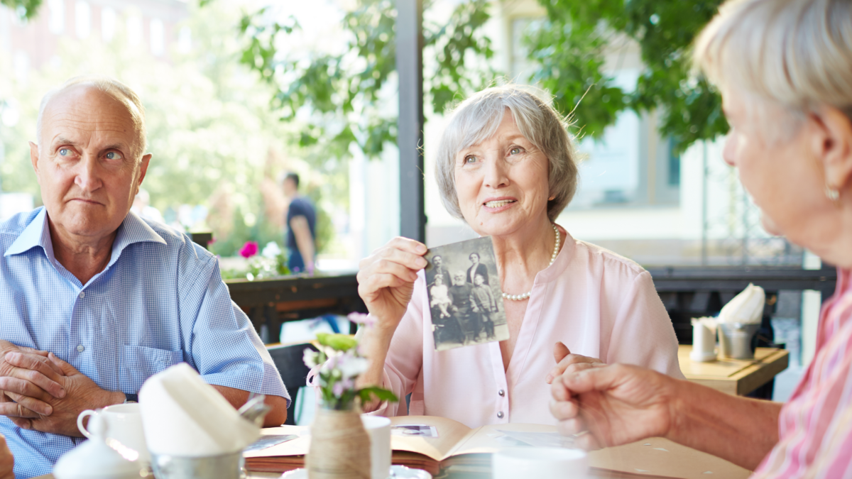 stock memory care woman shows photograph from past